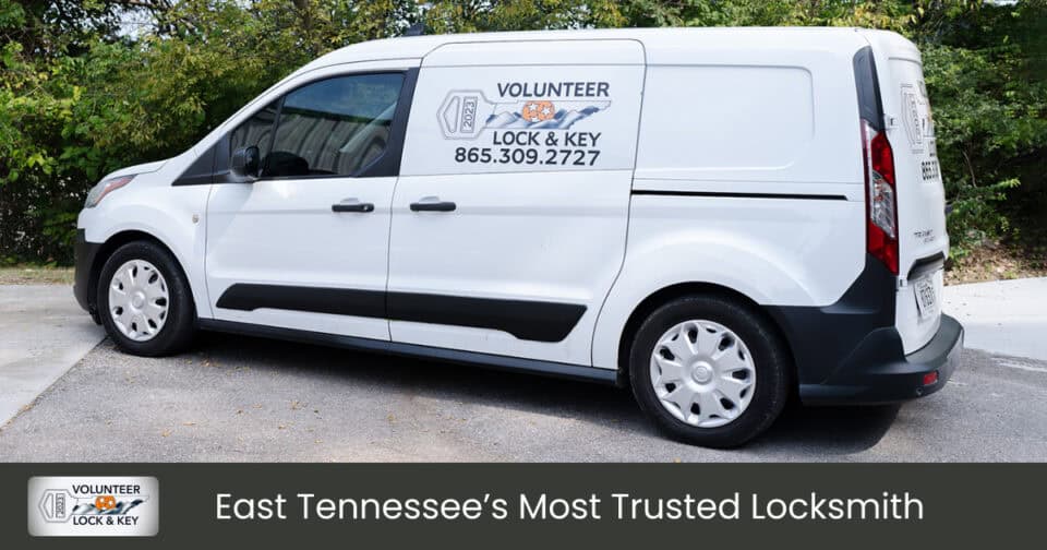 White van with "Volunteer Lock & Key" branding, logo, and contact information (865-309-2727) parked on a driveway. Caption below reads: "East Tennessee’s Most Trusted Locksmith.